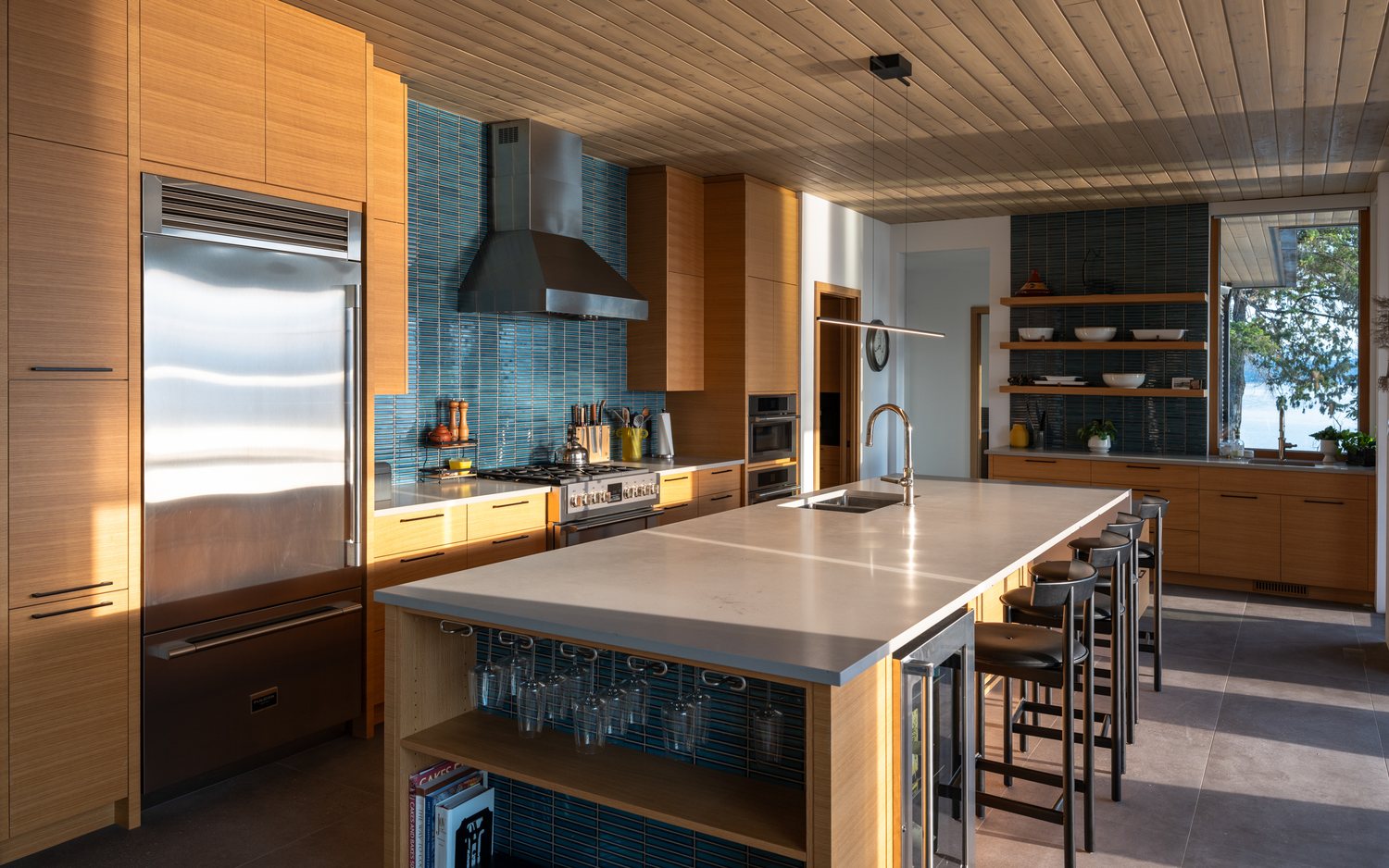 Salt Spring Island kitchen, teal tile and a dining table set to the water