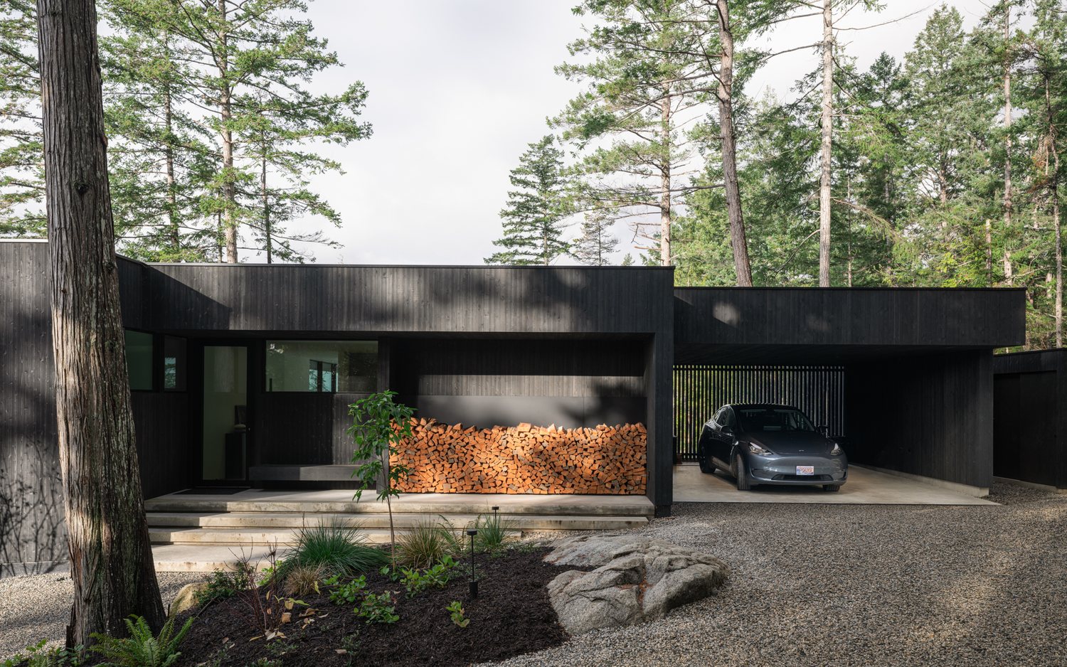 The Perch entry court, dark cladding under a wood soffit on the Sunshine Coast